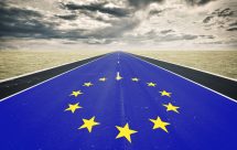 European flag, road perspective, dark clouds, crisis concept